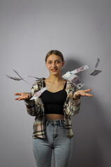 The girl throws euro banknotes up.