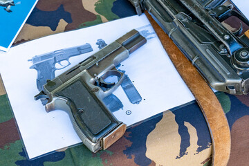 Hungarian 96M semi-automatic pistol and its description on a camouflage table