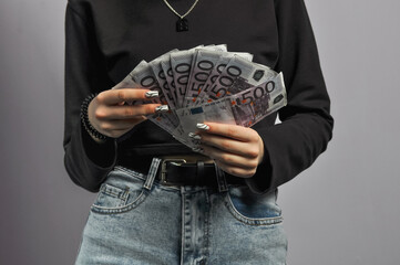 Euro banknotes in the hands of a girl