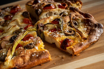 Focaccia with roasted tomatoes, olives, and scallions