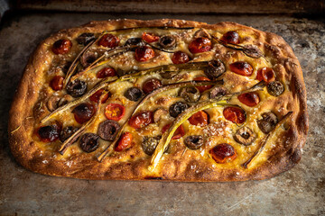 Focaccia with roasted tomatoes, olives, and scallions