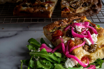 Focaccia with roasted tomatoes, olives, and scallions