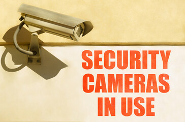 A CCTV camera is installed on the wall of the building, next to it is written - security cameras in...