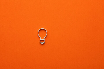 Light bulb on orange color background - Concept of creativity and innovation, graphic resource for design