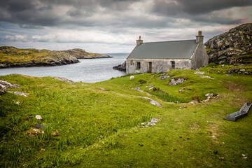 Blue rowing boat and white cottage near to Flodbay on the Isle of Harris