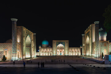 Fototapeta na wymiar Night panorama of Registan square with beautiful backlights and motion blurred people. Samarkand , Uzbekistan.