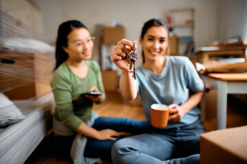 Close up of happy women with key of their new apartment.