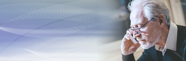 Portrait of senior modern man talking on mobile phone; panoramic banner