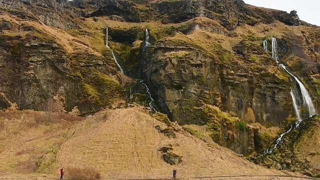 Gljufrabui, Iceland - 15th march, 2023: tourist reach in wet conditions Gljurfrabui waterfall. Small waterfall by Seljalandsfoss