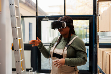 Stockroom supervisor enjoying using virtual reality goggles in warehouse, analyzing goods...