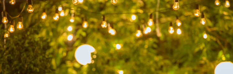 abstract background with light bulbs on trees in defocus