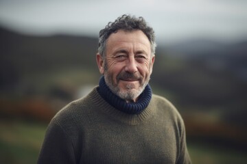 Portrait of a smiling middle-aged man standing outdoors in the countryside