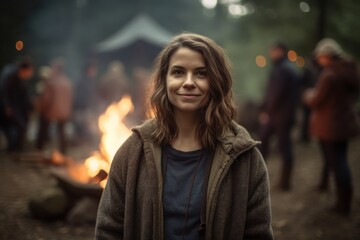 Portrait of a young woman in front of a bonfire.