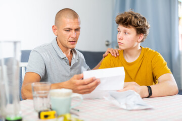 Father reassures his son after reading a letter from college