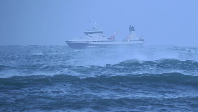 Fishing trawler in heavy storm ocean waves, Iceland