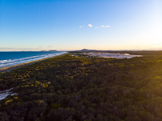 Aerial (drone) view spectacular coastline and Pacific ocean at sunset in Hat Head National Park, NSW, Australia