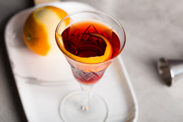 Boulevardier cocktail boozy bourbon whiskey, bitter and sweet vermouth with orange peel as garnish