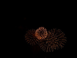 Fototapeta premium four orange fireworks on a black background