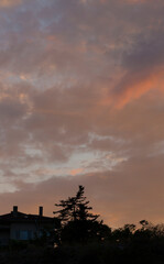 Colorful sunset over the Bulgarian town of Balchik. Cumulus clouds in a red-purple scale.