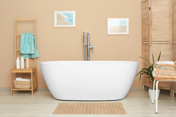 Fototapeta na wymiar Stylish bathroom interior with white beautiful tub