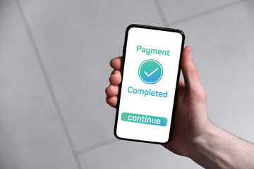 Man successfully made payment using online banking application on smartphone indoors, closeup