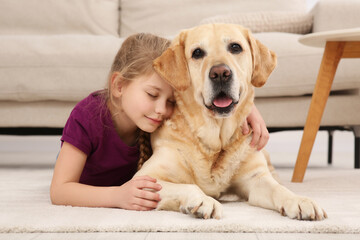 Young girl with her adorable dog on floor at home