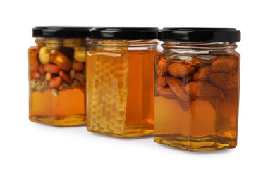 Jars with different nuts and honey on white background