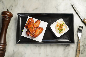 Spicy Chicken Wings with dip served in dish isolated on marble background top view on hong kong food