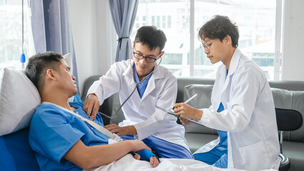 The medical team visits the car accident patients who are lying on the nursing bed and arm cast with wrapping nurse bandages splint to the arm.