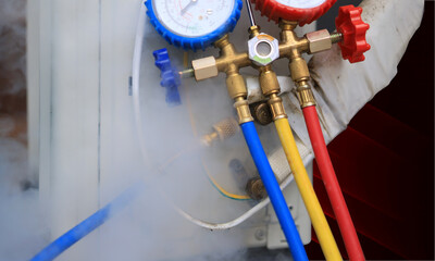 The refrigerant leaked, causing a white mist to emit from the outdoor unit. concept of air...