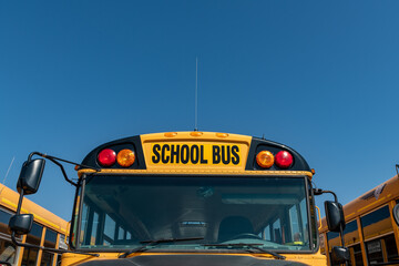 Yellow School Bus Windshield and Overhead Lights with Copy Space Blue Sky