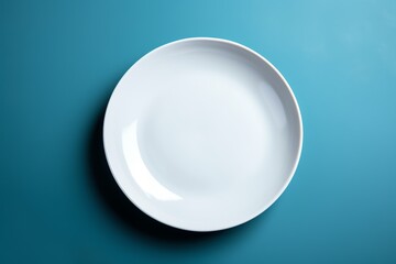 empty white plate on blue background