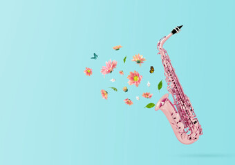 Composition made of pink saxophone retro style with colorful summer flowers and green leaves...