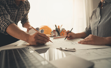 Architects, engineers, contractors working in the office with blueprints, inspection engineers Work analysis for architectural plan, construction project sketch, focus, business construction concept.