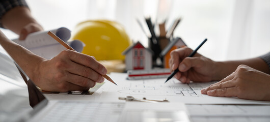 Architects, engineers, contractors working in the office with blueprints, inspection engineers Work analysis for architectural plan, construction project sketch, focus, business construction concept.