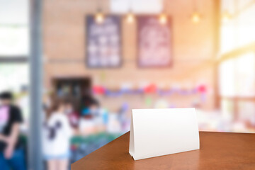 Menu frame mockup standing on wooden table in cafe restaurant bar. Space for text. Blank menu frame label mockup in restaurant bar stand.