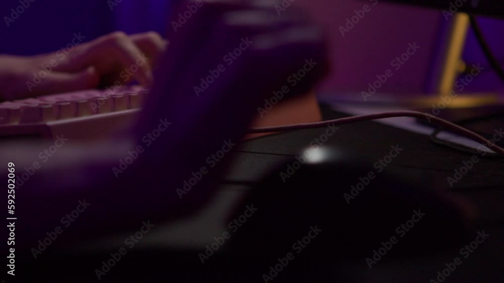Poster close-up of man playing computer games. stock footage. hand moves mouse and presses keyboard during 