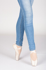 En Pointe CORRECT third position with blue jeans front on teachers perspective Young female ballet dancer showing various classic ballet feet positions blue jeans