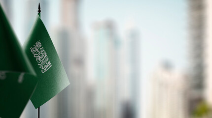 Small flags of the Saudi Arabia on an abstract blurry background