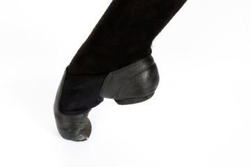 Black Jazz INCORRECT en pointe position Close up of young female ballet dancer showing various classic ballet feet positions for jazz ballet or dance against a white background in black shoes