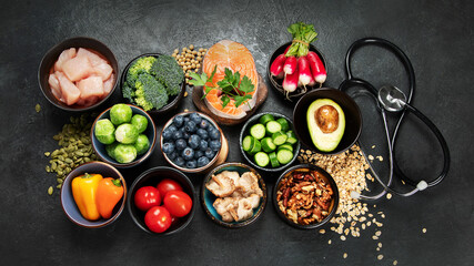 Food for a healthy heart concept and  stethoscope on black background