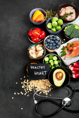 Food for a healthy heart concept and  stethoscope on black background