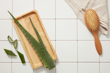 Scene for advertising cosmetic with aloe vera ingredient - fresh aloe vera on wooden dishes, wooden...