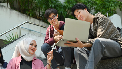 Fototapeta premium Group of students are working on academic project or preparing for exam together. Education, Learning and technology concept