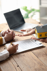 House sales representatives, sales representatives recommend housing details in the project to customers who are interested in viewing the houses in the project. Real estate trading concept.