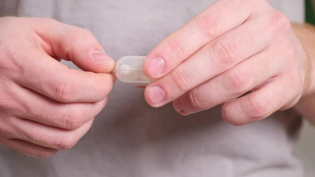 A man inserts earplugs in his ears so as not to hear extraneous noise, music, snoring. Silicone earplugs for sleeping.