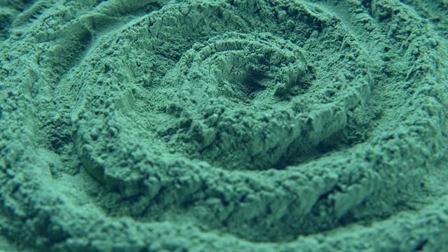 Chlorella or spirulina algae green powder is spinning, rotation. Dietary supplement to improve health. Seaweed super food. Healthy food background. Vitamins and minerals to diet. Detox. Closeup video