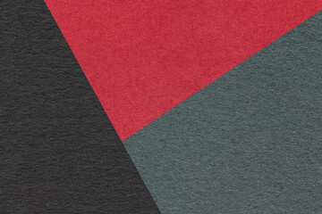 Fototapeta premium Texture of craft red, black and green shade color paper background, macro. Vintage abstract olive cardboard