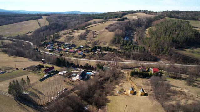 Aerial backwards view of rural area of Polanczyk. Poland. Daylight