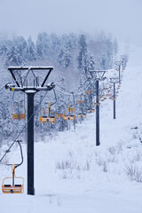 Teletsky Altai winter mountain ski resort near Iogach. Elevator on mount and forest background...